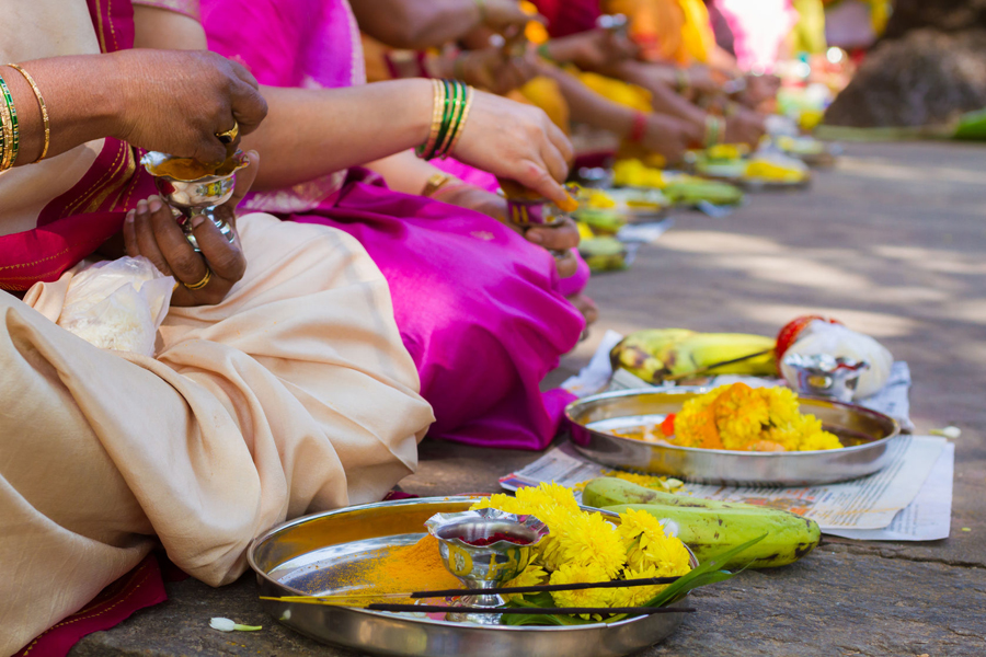 Hindu ladies peform a ritual offering to the Devi